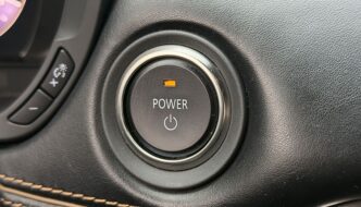 A close up of a car starter power button