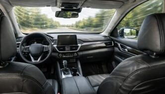 The inside of a vehicle with a view as if you are sitting in the rear left seat